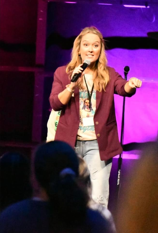 Shea Pirtle speaking on stage with microphone